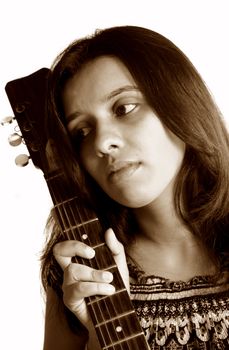 A portrait of a beautiful indian guitarist lost in her dreams.