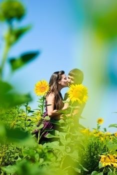 Young happy couple on the field. Shoot on the nature.