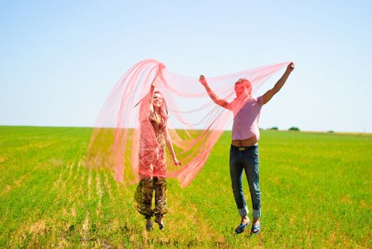 Young happy couple on the field. Shoot on the nature.
