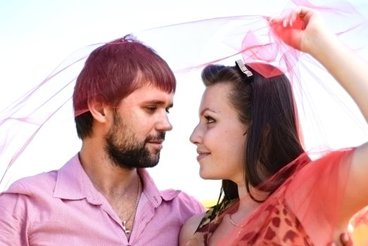 Young happy couple on the field. Shoot on the nature.