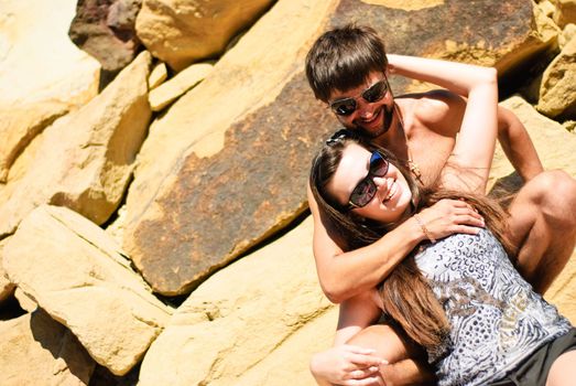 Young happy couple on the rocks. Shoot on the nature.