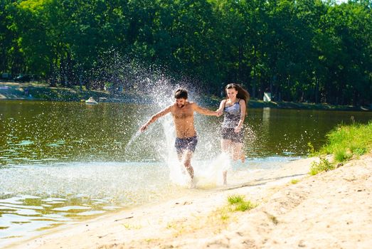 Young happy couple on the beach. Shoot on the nature.