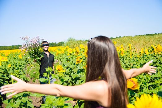 Young happy couple on the field. Shoot on the nature.