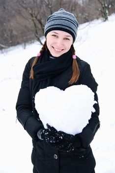 portrait of lovely young woman with heart of snow