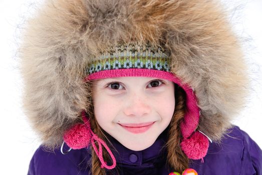 portrait of nice little girl in a winter clothes