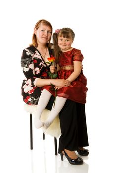 Mother with daughter sitting on chair isolated on white