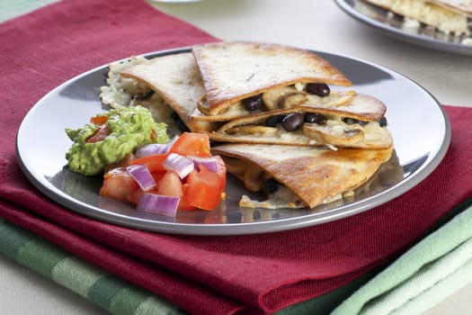 Black bean, mushroom and cheese quesadillas with salsa and guacamole.