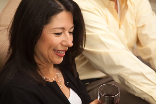 Attractive Hispanic Woman Enjoying Wine with Friends.