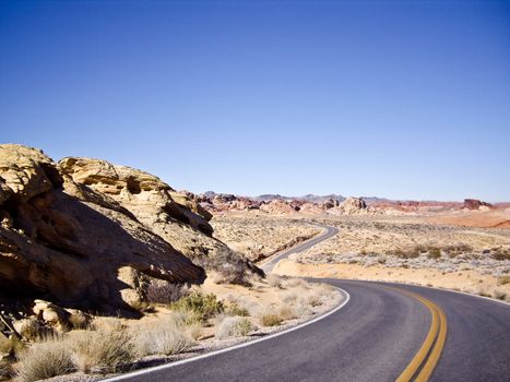 Long and winding desert road curves into the distance