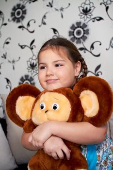 A little girl with a big plush toy.