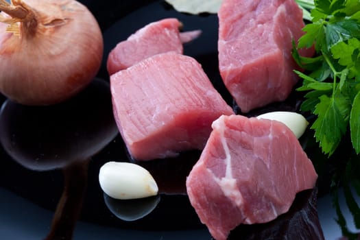 food series: cube sliced raw meat, onion, gralic on black