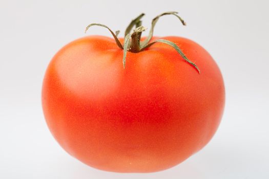 Tomato on a light background. Picture for a food, antioxidant, healthy food