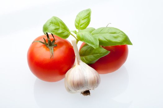 Tomato, mint and garlic on a light background. Symbols of Mediterranean cuisine