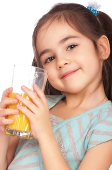 Portrait of happy little girl drinking orange juice