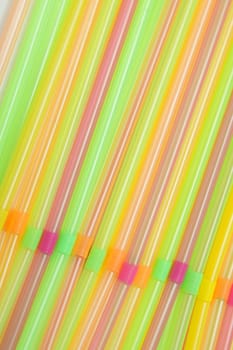 Party straws of various colors, closeup photo