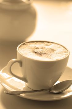 Cup of hot cappuccino, close-up. At the bottom  copyspace. Image tinted