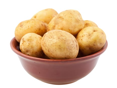 Many young potatoes in a clay bowl isolated on white background