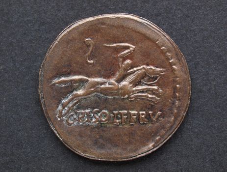 Ancient Roman coin on a black background