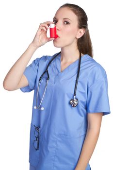Pretty nurse using asthma inhaler