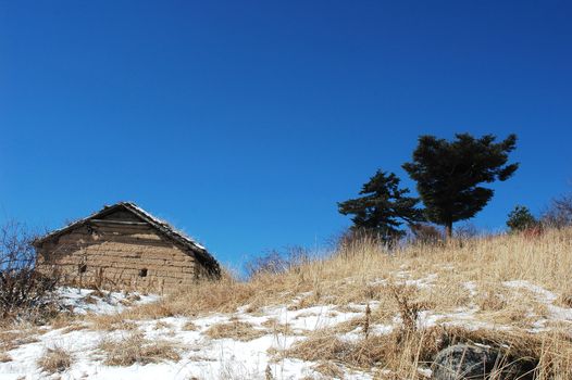 Landscape of a hut on the top of mountains in winter