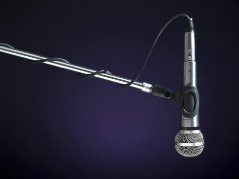 A microphone on a boom over a blue background.