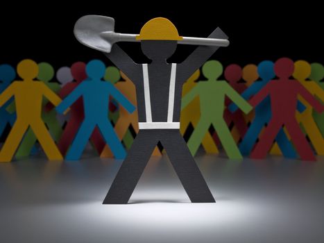A paper construction worker stands under the spotlight with a shovel upon his shoulders.