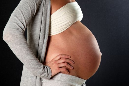pregnant woman with a big belly, photographed side-
 