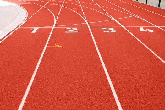 Close up of numbers on red running track.