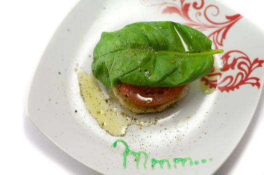 Caprese salad close-up with olive oil green basil and  pepper 