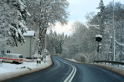 Road leading through the snowy forest