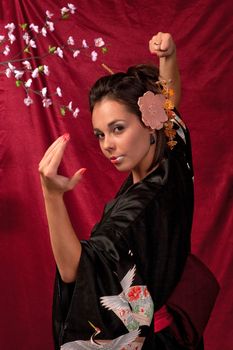 Japanese girl in traditional clothes posing to the camera