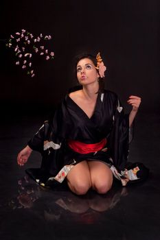 Japanese girl in traditional clothes posing to the camera