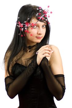 Beautiful woman playing with red feather wearing bijouterie isolated on white