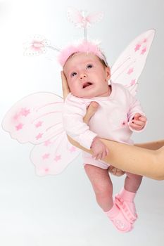 Baby in age of one month dressed as butterfly