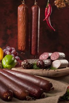 A composition of different sorts of sausages on dark background