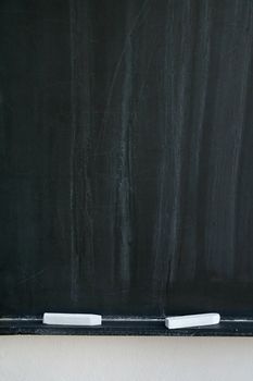 blackboard with two white chalks, detail photo