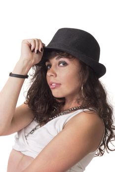 young brunette girl make pose for camera and touch her hat