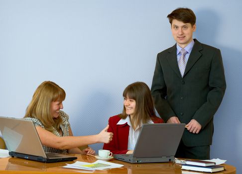 Girls sitting at a desktop and their chief