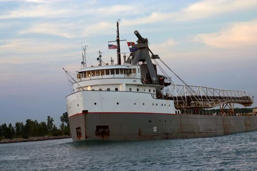 This is a picture of a Great Lakes ore hauling freighter going northbound on the Detroit River in the late summer afternoon.