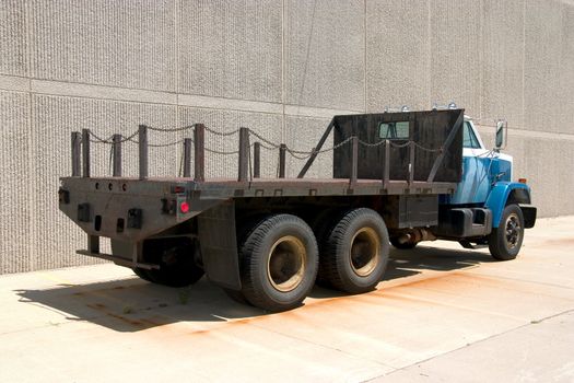 This is the rear view of a large flat bed stright truck.