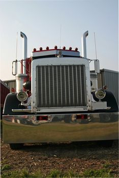 This is a picture of the front of a large semi truck, taken at a low stance with a slight angle to give the feeling of movement and power.