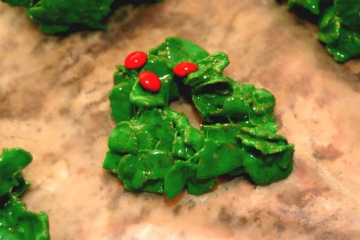 This is a Christmas cookie that is made with marshmallows melted in butter, green food dye and breakfast flakes with red cinnamon candies on top.