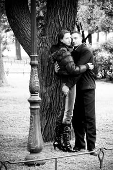 Happy young couple enjoying each other in park greyscale