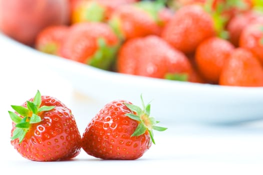 Delicious strawberries on white with shallow depth of field.