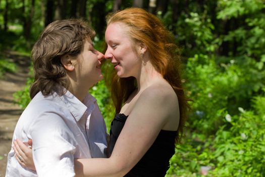 Two Girlfriends kissing in summer forest vacations