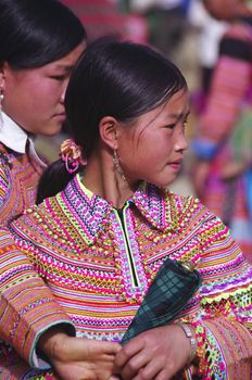 Girl Hmong flowered in market of Can Cau. The market is held weekly appointment for the young. Families were isolated in the mountains and their meeting place.