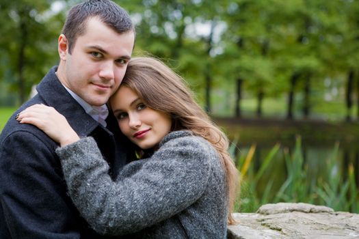 Two young lovers enjoying each other in park