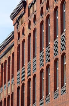 Wall of the red brick school with white windows