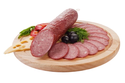 Sliced sausage with vegetables on a wooden plate isolated