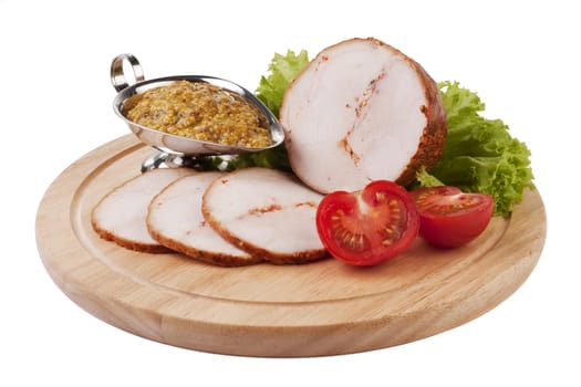 Sliced ham with mustard and vegetables on a wooden plate isolated